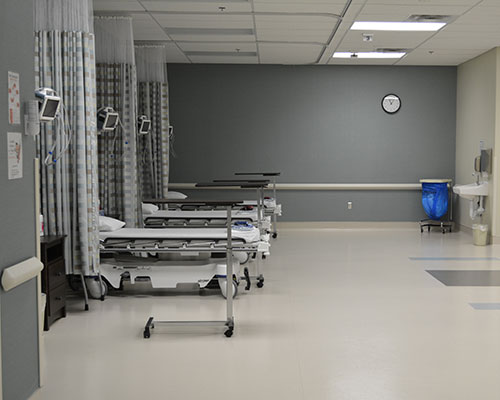 Hospital ward with empty beds.