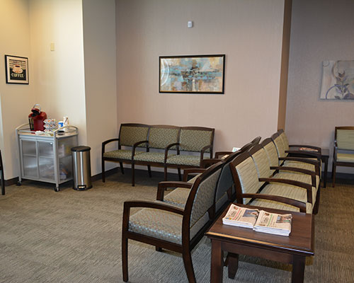 Waiting room with chairs and coffee station.