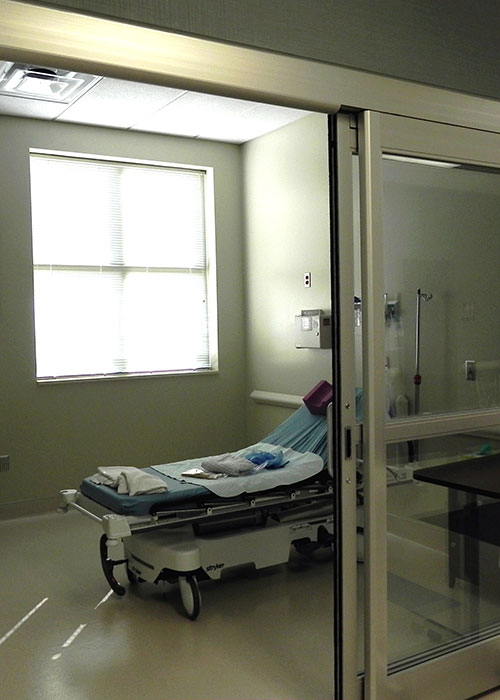 Empty hospital room with a gurney.