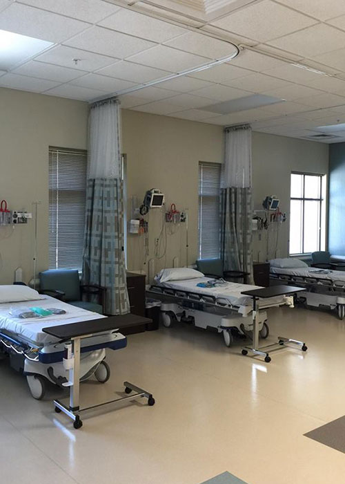 Hospital ward with several patient beds.