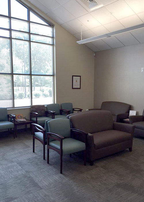 Waiting room with chairs and sofa.