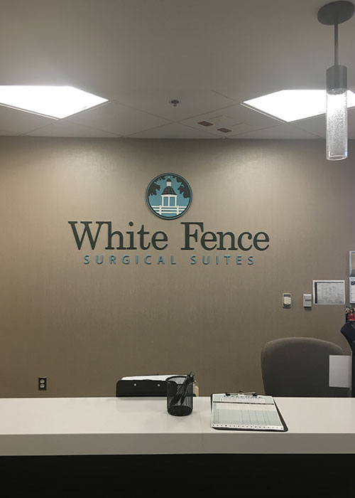 White Fence Surgical Suites logo.