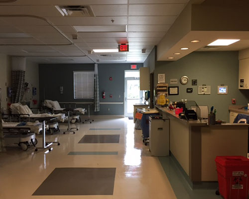 Hospital waiting area with empty beds.