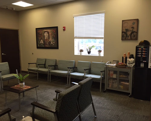 Waiting room with chairs and refreshments.