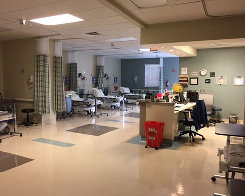 Hospital ward with empty patient beds.